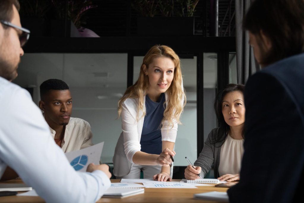 Professional in discussion with others during meeting