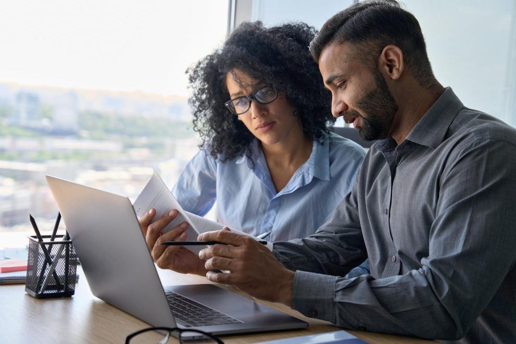 2 professionals working together on laptop