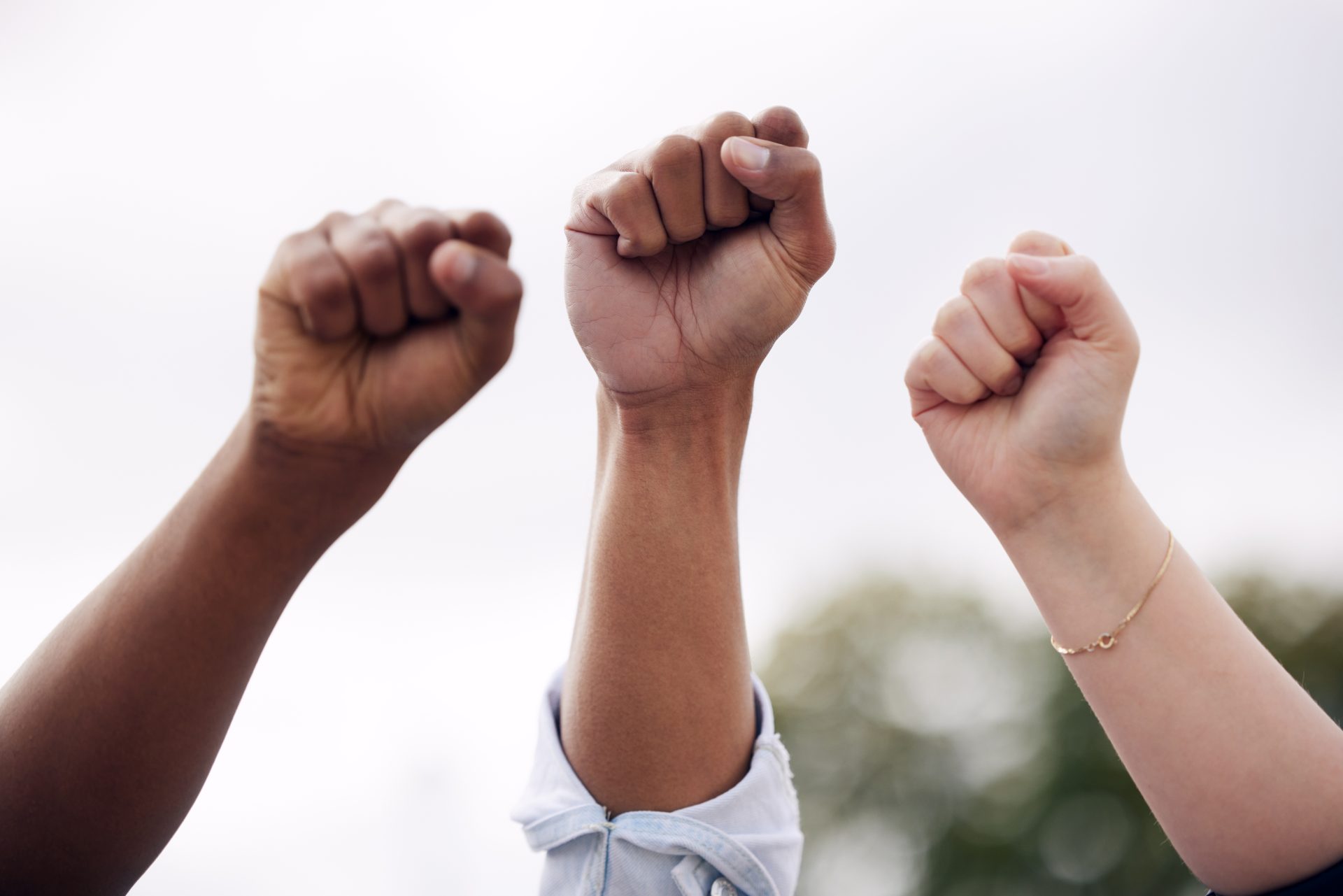 Hands raised in the air with closed grip